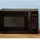 A screenshot of the Amazon Basic Microwave, it is black sitting on a wooden desktop